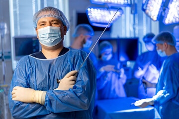 Surgeon ready in OR. A confident surgeon stands in the operating room, ready for a procedure with...