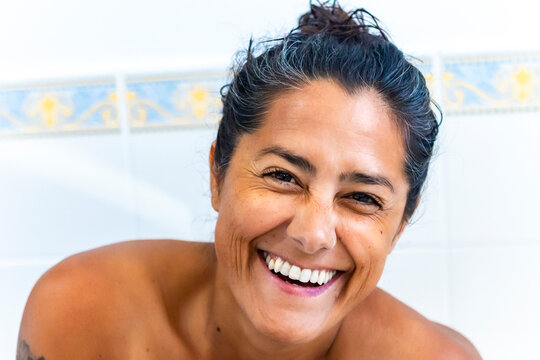 Captivating Smile of a Woman in Bright Natural Light on a Bathroom