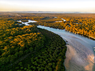 Aerial View of Lush River Winding Through Dense Forest in Jervis Bay