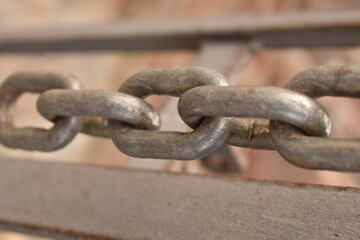 Naklejka premium Detailed view of steel chain. Concept of reliability, force, and secure connection.