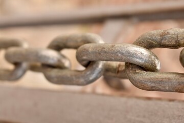 Close-up of metal chain links. Symbol of connection, strength, and industrial durability.