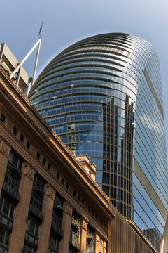 Fototapeta Modern skyscraper with glass facade towering over city of Sydney