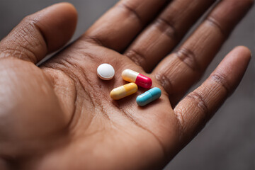 Hand holding medication pills for treatment