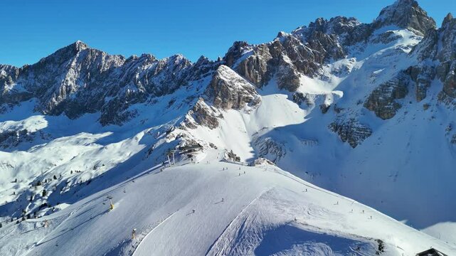 Cortina d'Ampezzo, Italy: Aerial view of famous ski resort in Dolomites (Dolomitic Alps)  and venue of Winter Olympics Milano Cortina 2026, sunny day - landscape panorama of Europe from above

