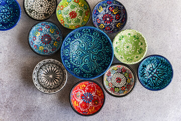 Colorful Hand-Painted Ceramic Bowls on Stone Surface