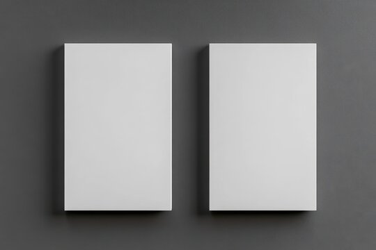 Two blank white rectangular objects, likely business cards or similar, positioned side-by-side against a dark gray backdrop.  Empty, ready for printing or customization
