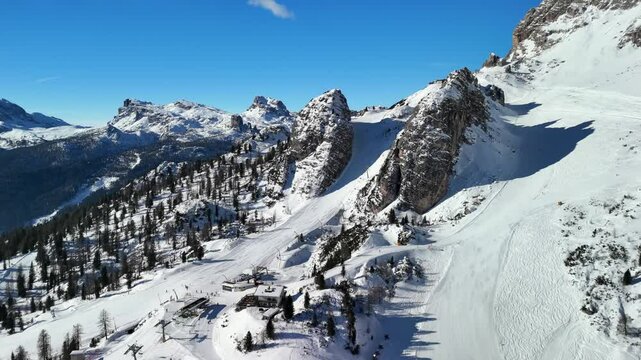 Cortina d'Ampezzo, Italy: Aerial view of famous ski resort in Dolomites (Dolomitic Alps)  and venue of Winter Olympics Milano Cortina 2026, sunny day - landscape panorama of Europe from above
