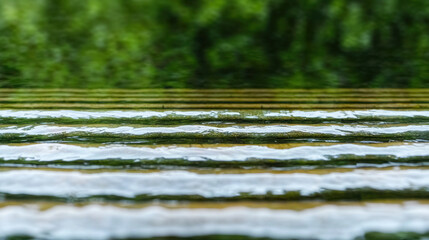 Gentle water flowing over layered surfaces creates serene and calming atmosphere