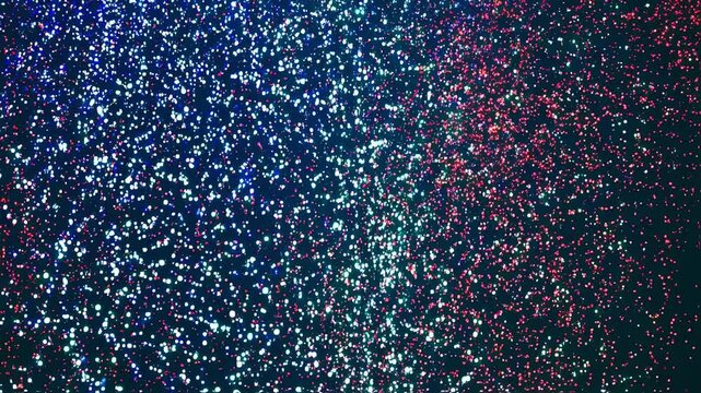 A mesmerizing light show illuminates the night sky with shimmering hues of blue, red, and green as a crowd gathers to enjoy the festive atmosphere. Laughter and cheers echo all around.