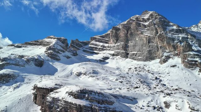Cortina d'Ampezzo, Italy: Aerial view of famous ski resort in Dolomites (Dolomitic Alps)  and venue of Winter Olympics Milano Cortina 2026, sunny day - landscape panorama of Europe from above
