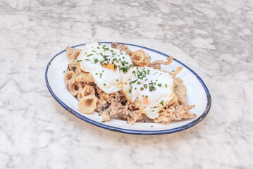 A wonderful tapa of Andalusian-style fried squid with a couple of fried eggs on top