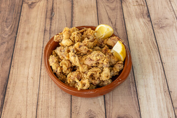 A wonderful tapa of Andalusian-style fried squid in a terracotta container