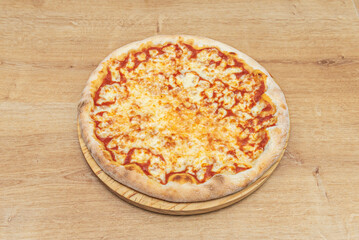 A delicious margherita pizza on a round wooden board