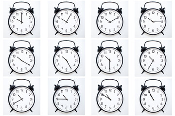 A set of 12 Black Vintage Alarm Clocks showing time from 10:00 to 10:55 or 22:00 to 22:55. Isolated...