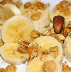 Sliced Banana and Granola. Breakfast with Fruit and Granola. Morning Meal Close-up. Sliced Banana with Selective Focus.