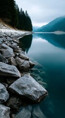Serene lake reflecting a misty mountain range