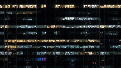 Office windows illuminate late night business operations.