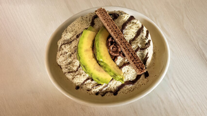 Delightful ice cream avocado dessert creation with unique toppings on a white background