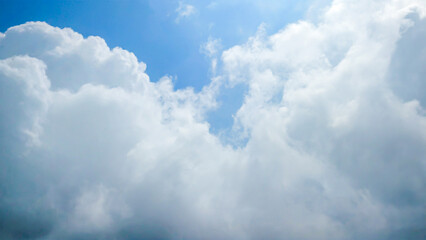 Expansive blue sky vista featuring fluffy cumulus clouds, heavenly scene