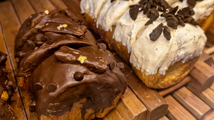Exquisite chocolate and vanilla pastries enticingly displayed on a wooden tray
