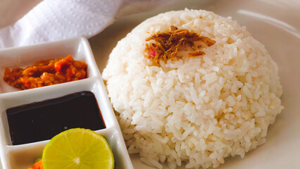 Exquisite Indonesian Nasi Liwet Presentation with Condiments and Fresh Lime