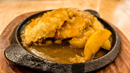 Delicious crispy fried chicken steak dish on a hot plate