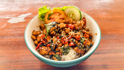 Flavorful chicken basil stir fry bowl with rice, showcasing vibrant colors
