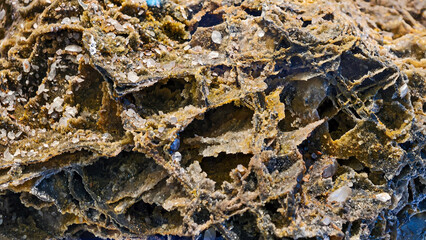 Intricate details of a weathered rock formation with crystalline structures