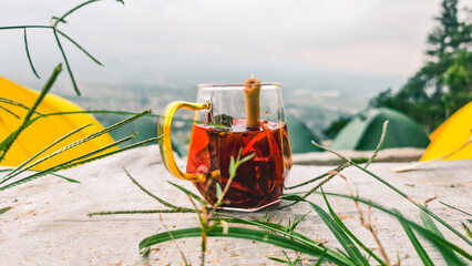 Aromatic herbal drink wedang uwuh amidst the serene natural scenery while camping. Made from...