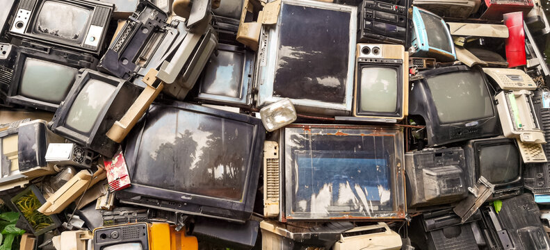 Pile of Vintage Televisions and Electronics Forming a Wall-like Structure