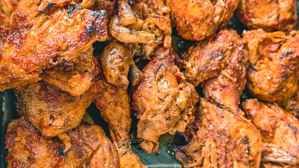 Roasted chicken pieces seasoned with spices display a rich and textured surface