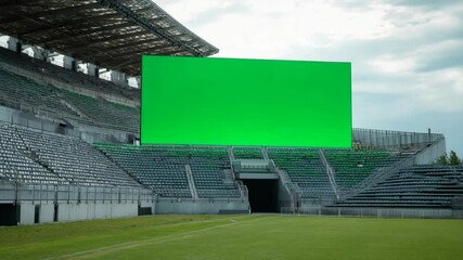 Large green screen in stadium.