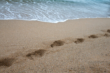 Footprints in the sand at the seashore