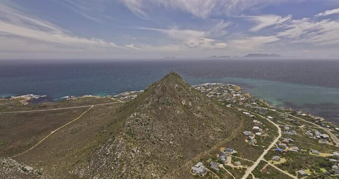 Pringle Bay South Africa Aerial v1 high flyover Hangklip summit capturing breathtaking views of foothill coastal village, mountain terrain, and False Bay - Shot with Mavic 3 Pro Cine - Jan 9th 2024