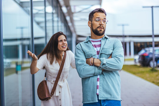 Argument Between a Woman and a Man Outdoors in Modern Urban Setting