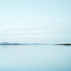 Fototapeta premium Serene seascape with distant mountains and island under a pale sky, minimalist landscape photography, calm water reflection, Croatia