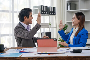 Business Colleagues High-Fiving in Office