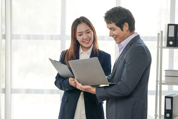 Business Colleagues Reviewing Laptop in Office