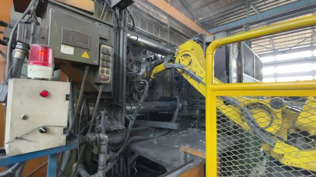Automated Industrial Machine Molding Metal Components in Manufacturing Facility