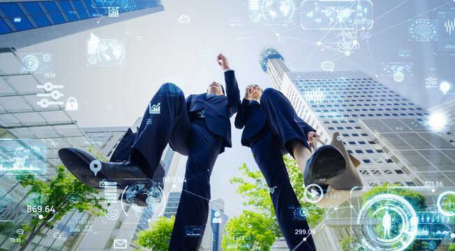 Jumping male and female business people and digital technology concept