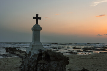 Sunset on Morjim Beach Goa. Christian Cross on the beach in north Goa India,