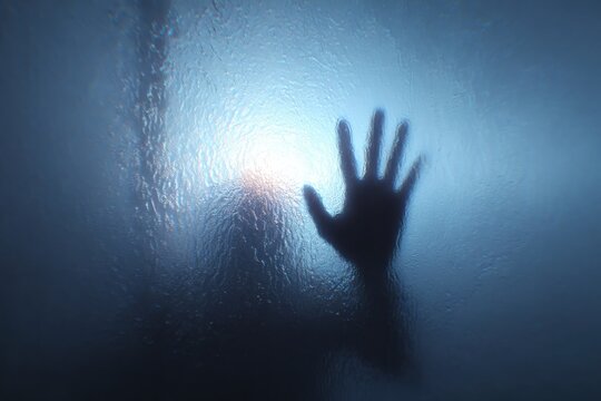 Foggy Glass Creating a Mysterious Atmosphere With a Blurry Hand Reaching Out, Perfect for Halloween