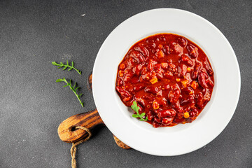Chile con carne plate beans, tomato, corn, meat fresh delicious gourmet food background on the table rustic food top view copy space