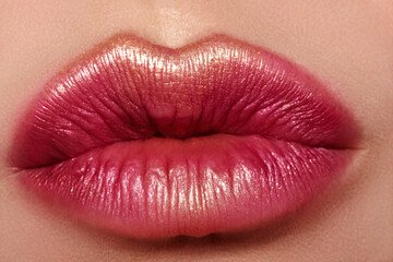 Glamour fashion bright red lips make-up with gold glitter. Macro of woman's face part. Sexy lip makeup, luxury visage