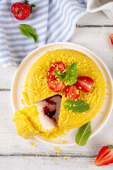 No-bake Upside Down Cheesecake, viral trendy version of classic Cheesecake New York with golden cookie crumbles, white cream cheese and berry jam layers, with fresh strawberry and mint on wooden table