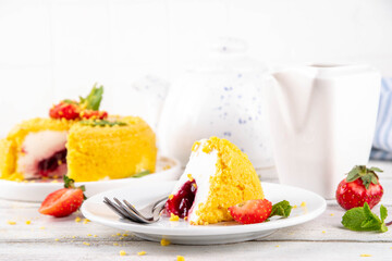 No-bake Upside Down Cheesecake, viral trendy version of classic Cheesecake New York with golden cookie crumbles, white cream cheese and berry jam layers, with fresh strawberry and mint on wooden table