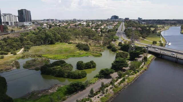 Aerial drone moves backward over nature reserve in Footscray, Melbourne, on a summer day