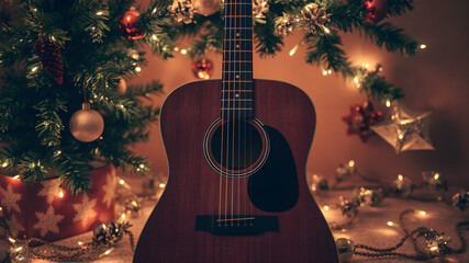 Acoustic guitar surrounded by warm lights and festive decorations