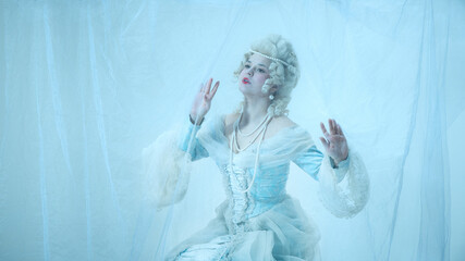 Dreamy woman as medieval duchess trapped behind sheer veil, styled in rococo gown, portraying...