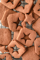 Shortbread chocolate cookies with curred star form on baking tray, close up top view